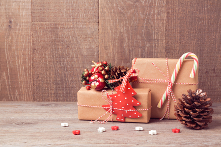 Christmas background with gift boxes and rustic decorations on wooden tableの写真素材