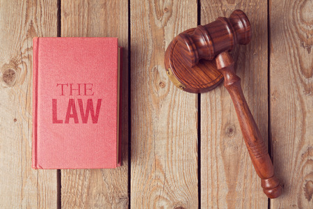 Law book and gavel on wooden background. Justice conceptの写真素材