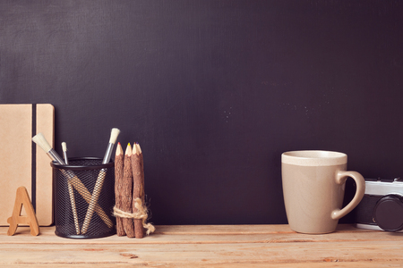 Website header design with designer vintage desk over chalkboard backgroundの写真素材
