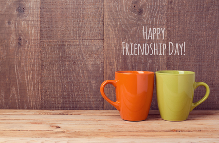 Coffee cups on wooden table. Friendship day celebration conceptの写真素材