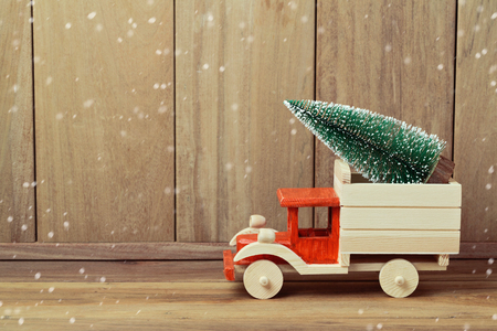 Christmas tree on toy truck car. Christmas holiday celebration conceptの写真素材