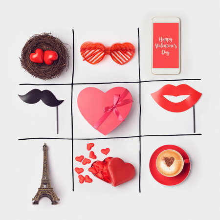 Valentine's day background with heart shape and party accessories. Tic tak toe game concept. View from above. Flat layの写真素材