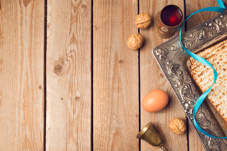 Jewish holiday Passover concept with matzah, seder plate and wine on wooden background. View from aboveの写真素材