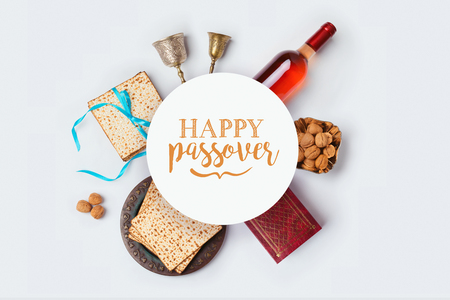 Jewish holiday Passover banner design with wine, matza and seder plate on white background. View from above. Flat layの写真素材