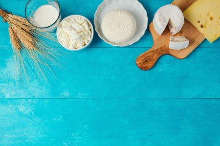 Milk and cheese, dairy products on wooden blue background. Jewish holiday Shavuot concept. View from aboveの写真素材