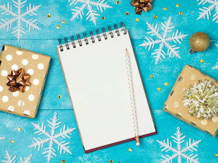 Notebook with gift boxes on wooden table.Christmas holiday background. View from above. Flat layの写真素材