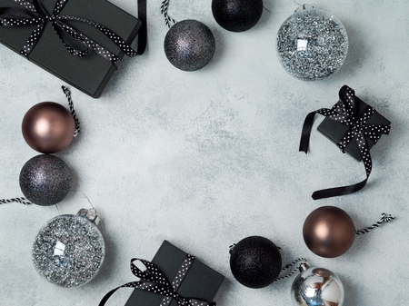 Christmas background with gift boxes and decorations in black and silver colors. View from above. Flat layの写真素材