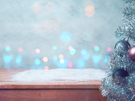 Christmas and new year concert background with empty wooden table. snow and lights bokehの写真素材
