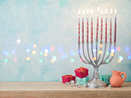 Jewish holiday Hanukkah background with menorah and gift boxesの写真素材