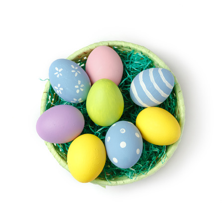 Easter eggs in basket isolated on white background. Top viewの写真素材