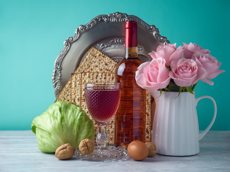 Passover holiday celebration concept with wine, matzo and seder plate.