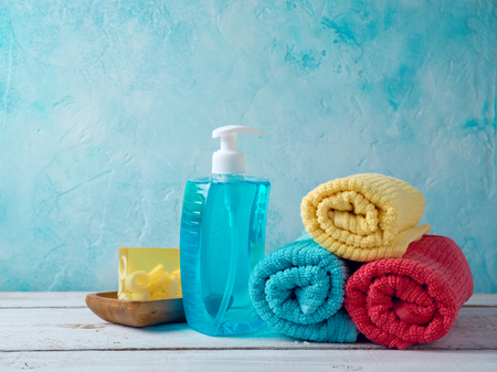 Soap and clean towels on wooden table. Bathroom backgroundの写真素材