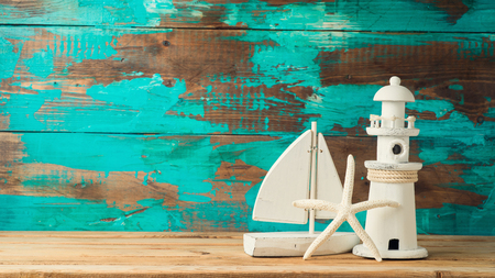 Starfish, boat and lighthouse decor over wooden background. Summer vacation conceptの写真素材
