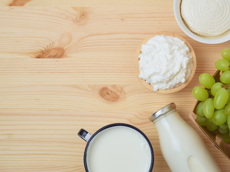 Milk and cheese, dairy products, fruits on wooden background. Jewish holiday Shavuot concept. Top viewの写真素材