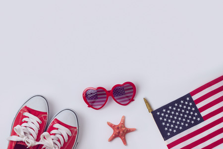 July 4th concept, Independence day celebration with USA flag, sunglasses and sneakers.View from above. Flat layの写真素材