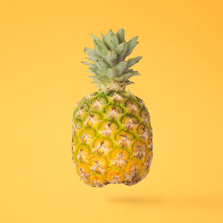 Pineapple over yellow background. Summer tropical concept. Creative minimal still life.の写真素材