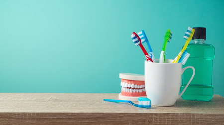 Dental care and hygiene concept with toothbrushes and mouthwash on table backgroundの写真素材