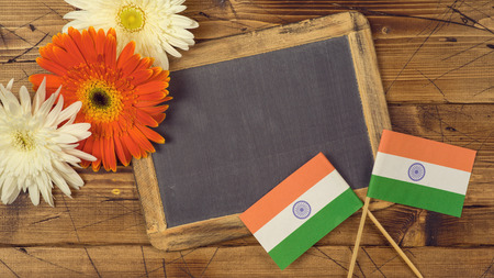 India Independence day background with indian flag, chalkboard and flowers. View from above