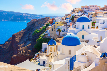 Santorini island, Greece. Oia town traditional white houses and churches with blue domes over the Caldera, Aegean sea.の写真素材