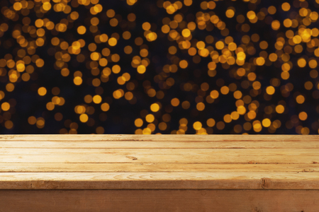 Empty wooden table over festive bokeh background. Christmas holiday concept