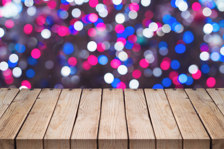 Empty wooden table over festive bokeh background. Christmas holiday concept
