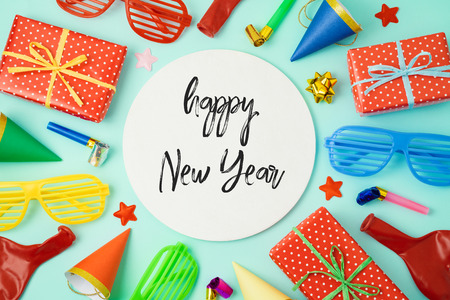 New year party celebration background with colorful balloons, party hats and gift boxes. Top view from above. Flat lay templateの写真素材