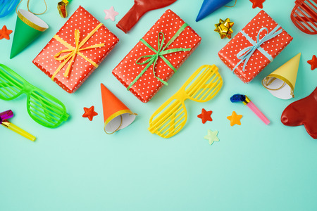New year party celebration background with colorful balloons, party hats and gift boxes. Top view from above. Flat lay templateの写真素材