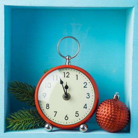 Christmas holiday composition with clock and  decoration on wooden shelf