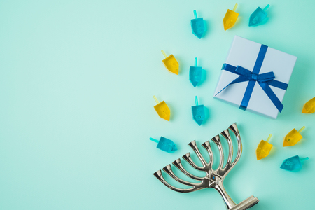Jewish holiday Hanukkah background with menorah, gift box and spinning top. Top view from above. Flat layの写真素材
