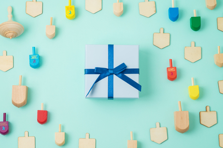 Jewish holiday Hanukkah background with gift box and spinning top. Top view from above. Flat layの写真素材