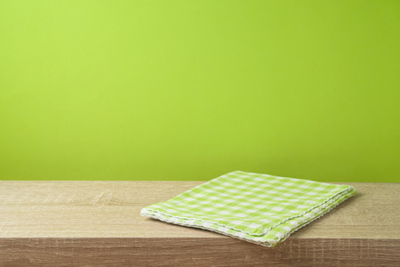 Empty wooden table with tablecloth over green wall  background.の写真素材