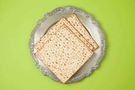 Jewish holiday Passover matzo and seder plate on green background.Top view from above. の写真素材