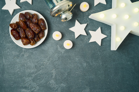 Ramadan kareem holiday background with dates fruit and stars. Top view from aboveの写真素材