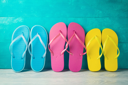 Summer concept background with flip flops on wooden table. Family vacation conceptの写真素材