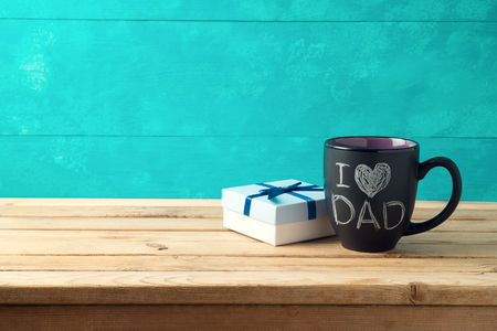 Happy Father's day concept with coffee mug and gift box over wooden backgroundの写真素材