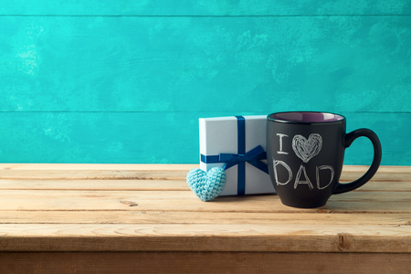 Happy Father's day concept with coffee mug and gift box over wooden backgroundの写真素材