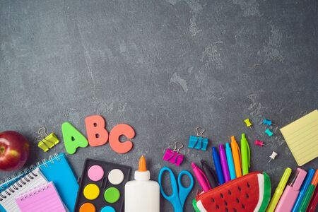 Back to school background with school supplies on blackboard. Top view from aboveの写真素材