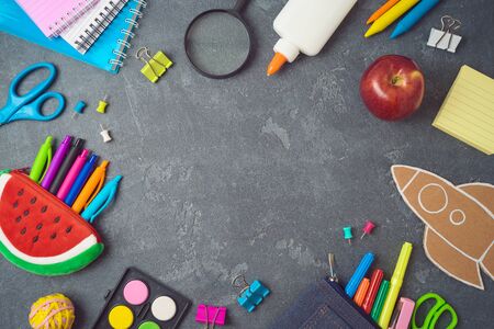 Back to school background with school supplies on blackboard. Top view from aboveの写真素材