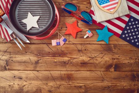 Happy Independence Day, 4th of July celebration concept with USA flag and barbeque grill  on wooden background. Top view from aboveの写真素材
