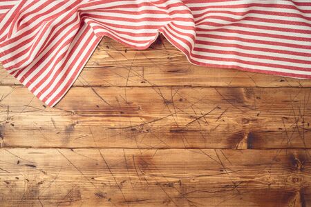 Wooden tabletop with striped tablecloth for kitchen or cooking food background. Top view from aboveの写真素材