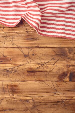 Wooden tabletop with striped tablecloth for kitchen or cooking food background. Top view from aboveの写真素材