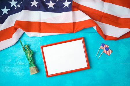 Happy Independence Day, 4th of July celebration concept with empty frame and USA flag on wooden background. Top view from aboveの写真素材