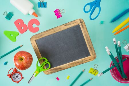 Back to school concept with school supplies flying over blue background. Top view from aboveの写真素材