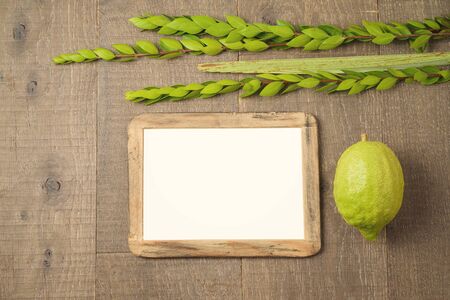 Jewish holiday Sukkot celebration background with picture frame