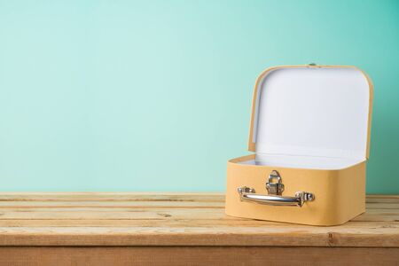 Empty suitcase box on wooden table with copy space. Background for product montage, display and advertising.の写真素材