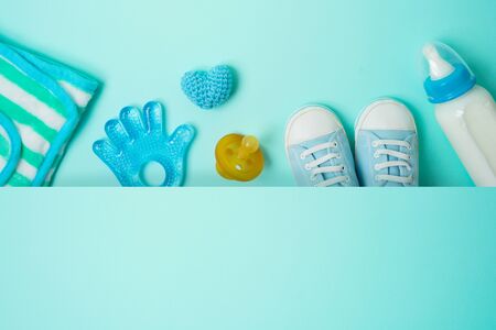 Newborn baby accessories over blue background. Top view from aboveの写真素材