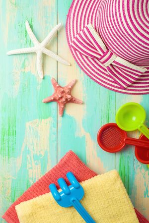 Summer background with beach items on wooden board. Top view from aboveの写真素材