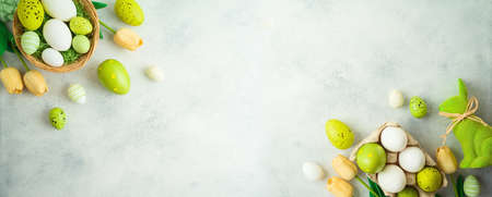 Easter holiday concept with Easter eggs and tulip flowers decor on gray background