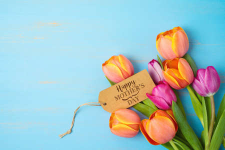 Happy Mother's day concept with beautiful tulip flowers  on wooden background with copy spaceの写真素材