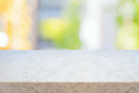 Empty marble table over bokeh background.  Summer mock up for design and product display. Selective focus on marble tabletop.の写真素材